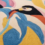 Close-up of a colorful rug with a stylized penguin design.