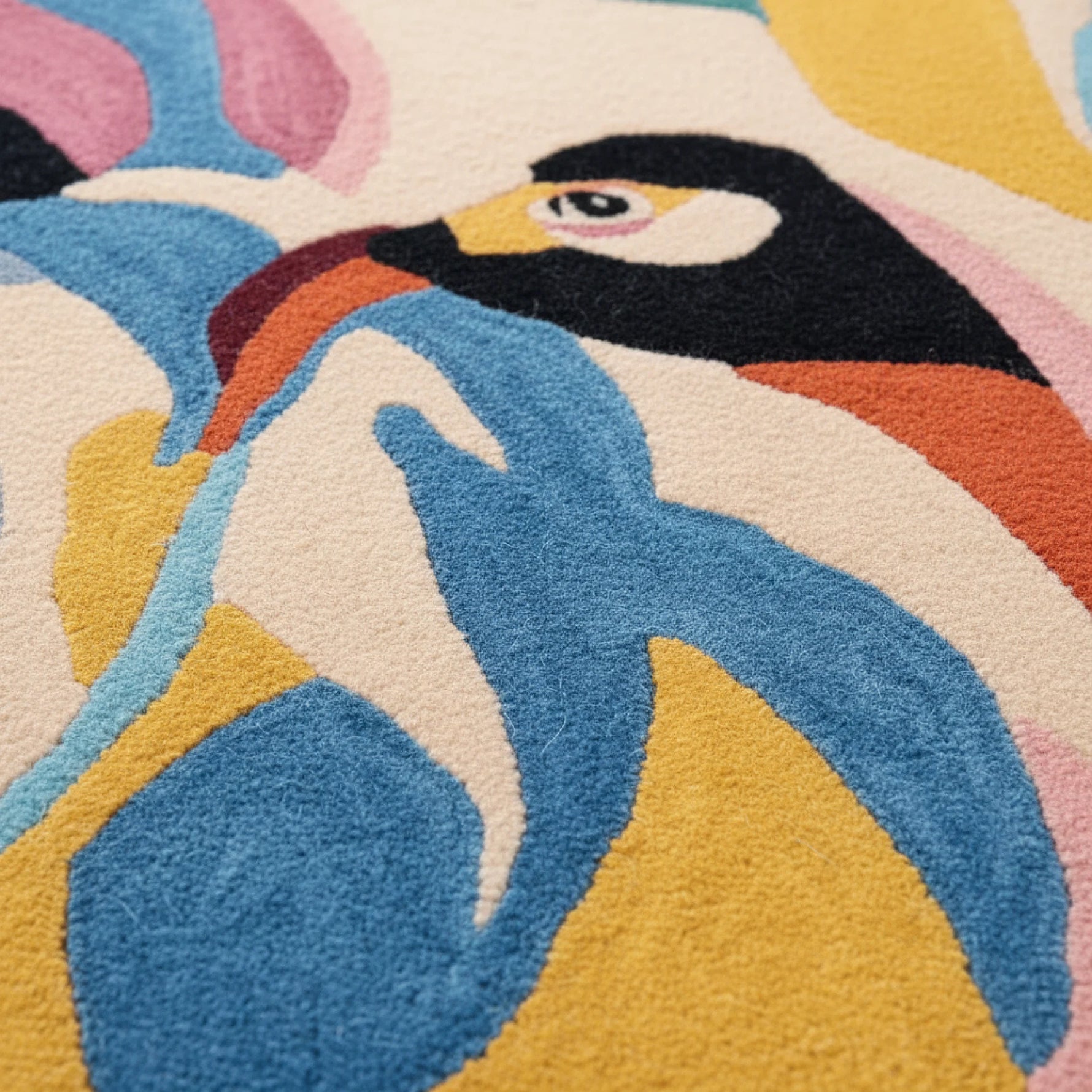 Close-up of a colorful rug with a stylized penguin design.