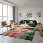 Modern living room with a colorful rug, green sofa, and abstract art on the walls.