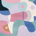 This vibrant area rug features an abstract design with bold colors like pink, blue, and green, creating a contemporary rug style. Made from high-quality wool, this large living room rug adds a modern touch to any space.