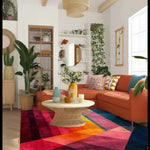 A vibrant and colorful area rug in an 8x10 size, perfect for contemporary living rooms or offices. The hand-tufted wool rug features a modern mosaic design with bold colors, complementing the stylish decor of a cozy living room setup with a wicker coffee table and orange sectional sofa.