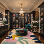 Luxurious closet with a colorful rug, ottoman, and decorative items.
