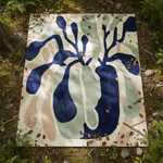 Abstract rug with blue, green, and pink shapes on a natural background