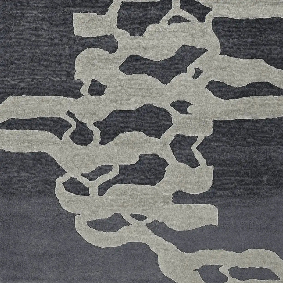 Top view of a Modern Psyche Flow Hand Tufted Area Rug, showcasing its contemporary abstract design in shades of grey and black. This wool rug is perfect for adding a stylish touch to living room area rugs, making it an ideal choice for area rugs for living room decor.