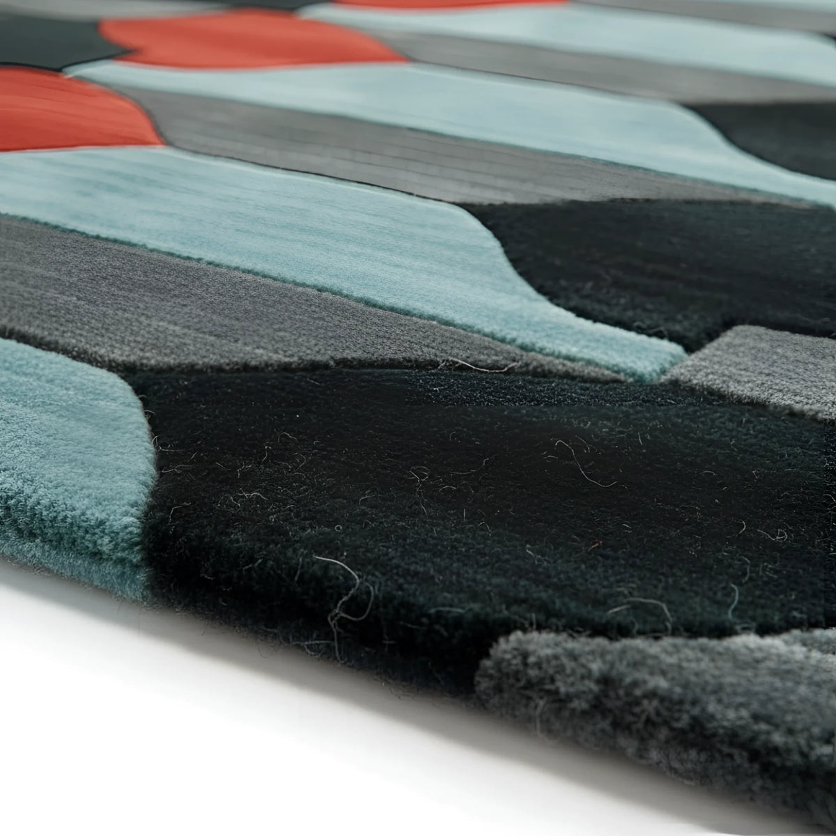 Close-up of a textured rug with geometric pattern on a white background