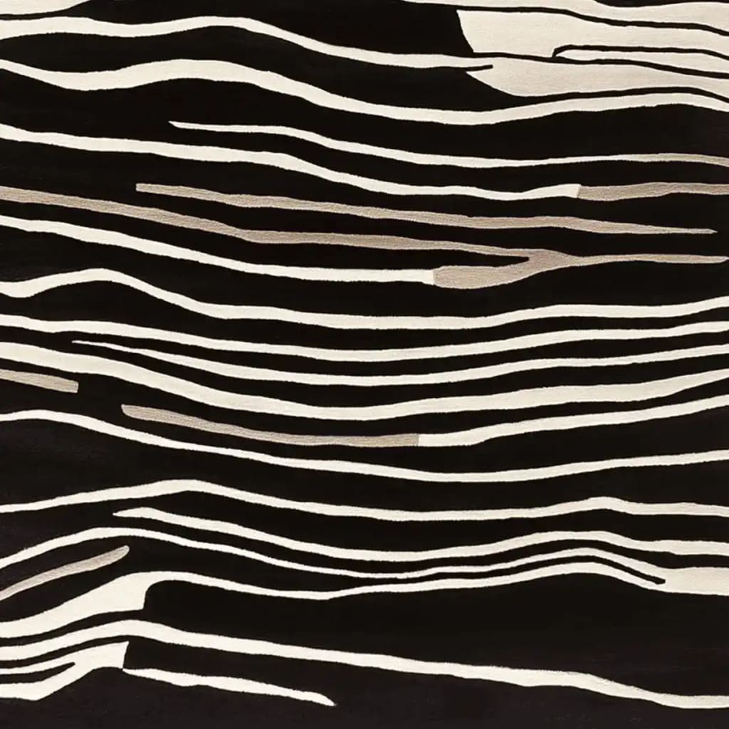 A striking area rug with a black and white abstract pattern, part of the Modular Art Beat collection. This contemporary wool rug, designed for living room spaces, showcases a hand-tufted texture with flowing lines that resemble natural forms.