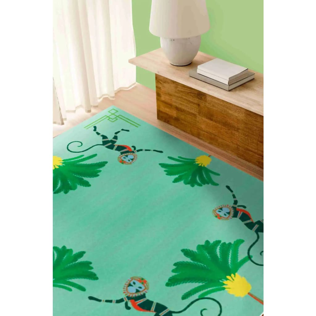 A vibrant hand-tufted wool area rug featuring whimsical monkeys and lush palm trees, perfect for adding a boho touch to your living room or office. The rug's playful design and soft texture make it an ideal choice for those seeking unique and stylish living room area rugs.