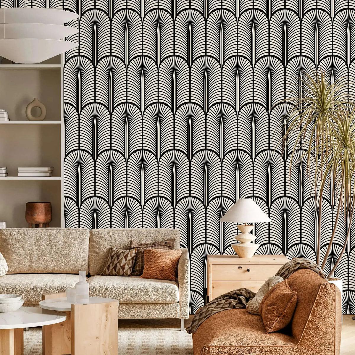 Monochrome Deco arch-and-frond wallpaper behind a cream boucle sofa and rust seating
