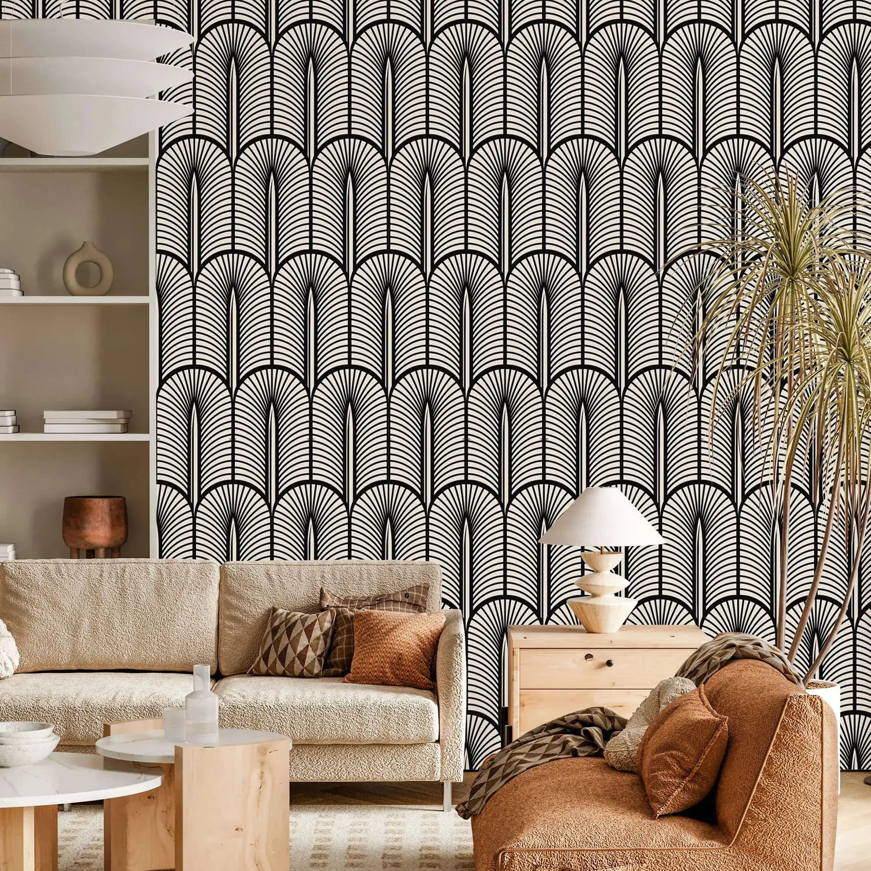 Monochrome Deco arch-and-frond wallpaper behind a cream boucle sofa and rust seating