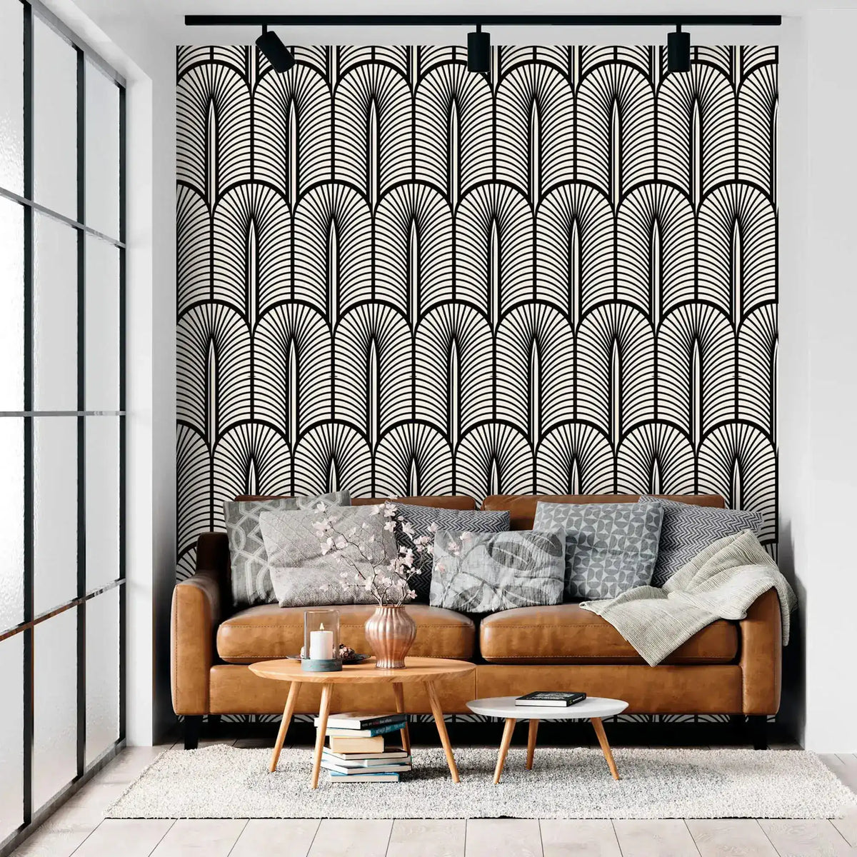 Monochrome Deco fan-pattern feature wall behind a tan leather sofa with grey cushions