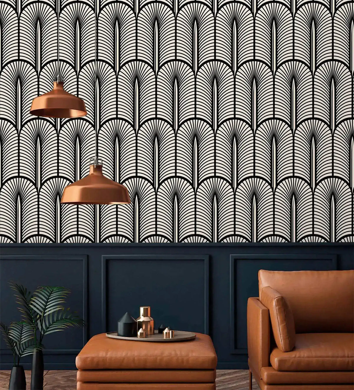 Monochrome Deco fan wallpaper above navy panelling with copper pendants and tan leather chair