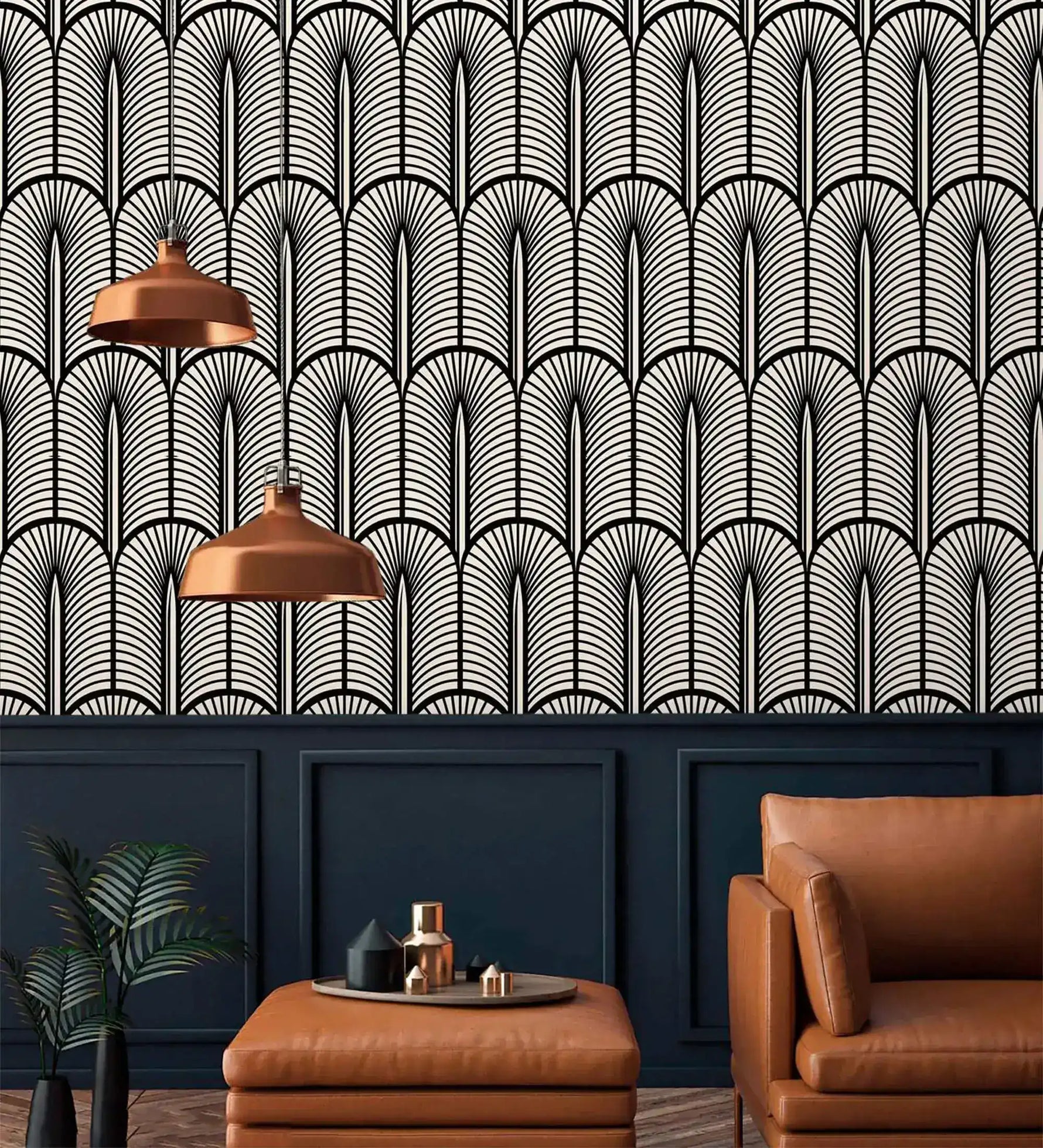 Monochrome Deco fan wallpaper above navy panelling with copper pendants and tan leather chair