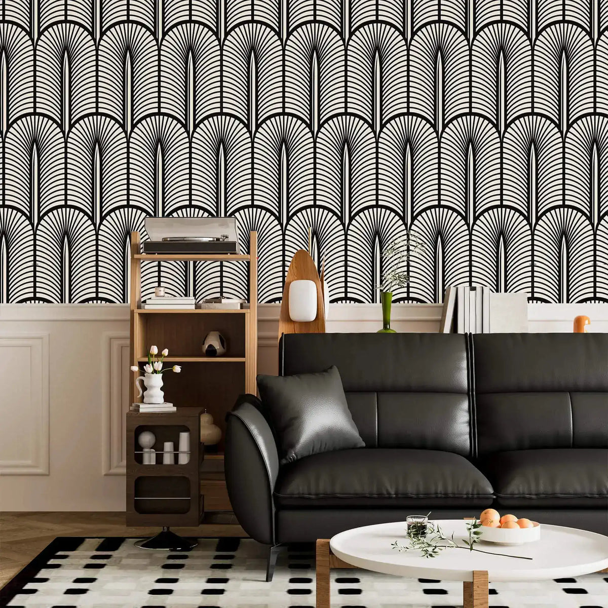 Monochrome Deco fan wallpaper above white panelling with a black leather sofa and ladder shelf