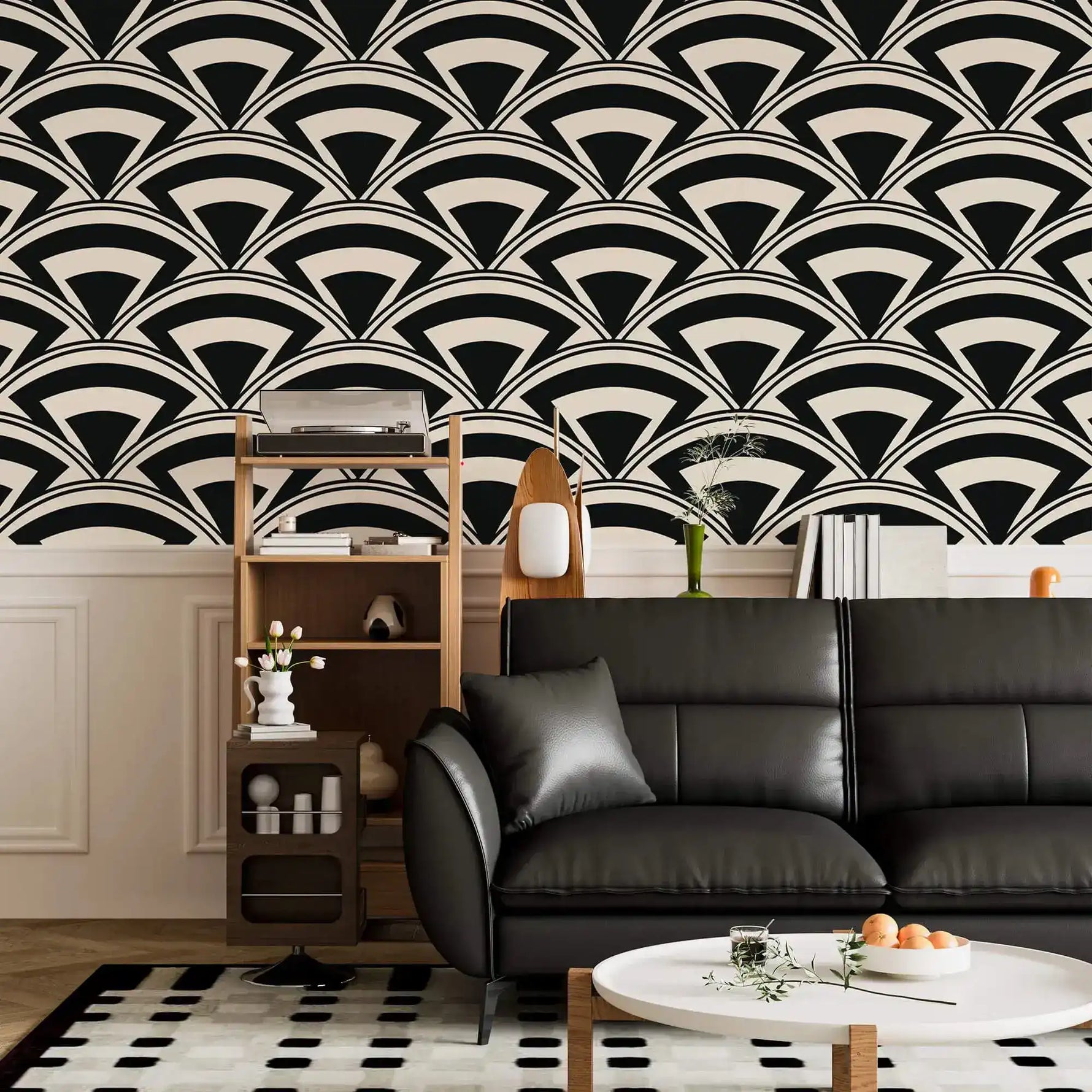 Monochrome deco fan wallpaper in black and cream above wainscoting with a black leather sofa and shelf