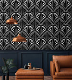 Monochrome Deco Floral Wallpaper backdrop with copper pendants and tan leather ottoman