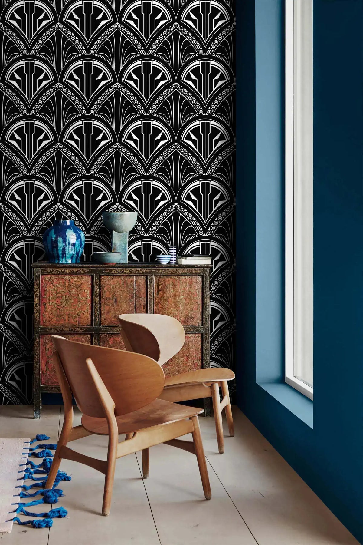 Monochrome Deco Floral Wallpaper in black and white beside a red cabinet and wood chairs
