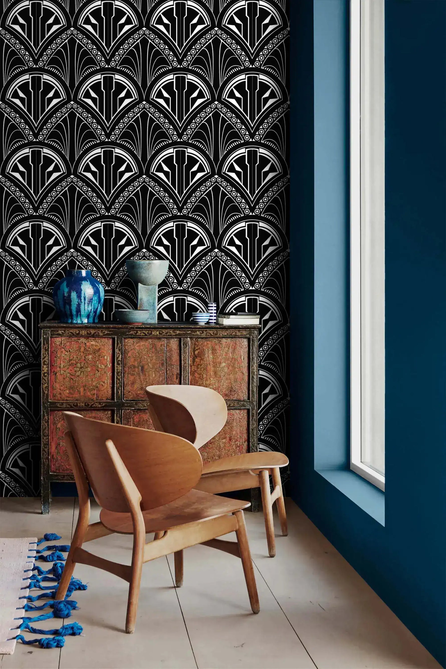 Monochrome Deco Floral Wallpaper in black and white beside a red cabinet and wood chairs