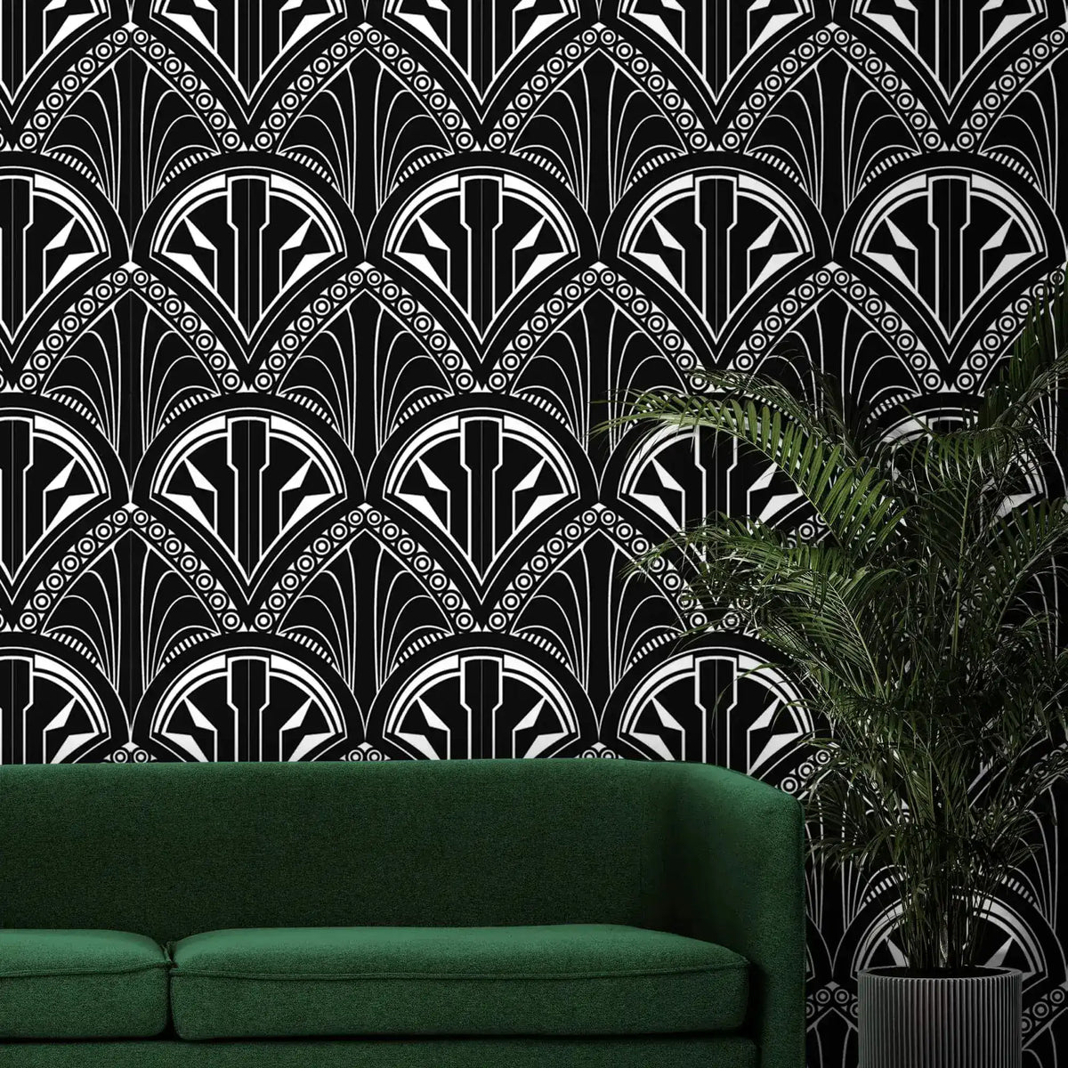 Monochrome Deco Floral Wallpaper in bold black and white above a green sofa and fern