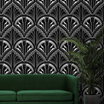 Monochrome Deco Floral Wallpaper in bold black and white above a green sofa and fern