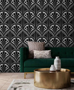 Monochrome Deco Floral Wallpaper of black and white Art Deco fans behind an emerald sofa