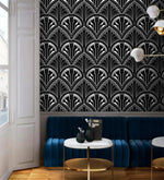 Monochrome Deco Floral Wallpaper of geometric fans above a navy banquette and marble table