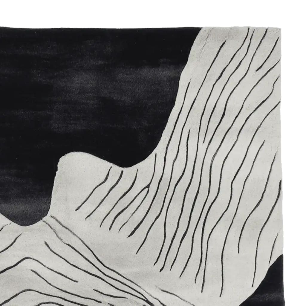 Close-up detail of a contemporary area rug with an abstract design featuring flowing black lines on a cream wool surface. Perfect for living room rugs 8x10, this hand-tufted wool rug adds a modern touch to any space.