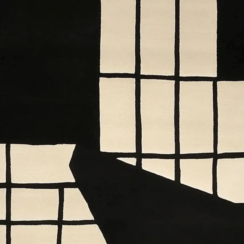 A contemporary wool area rug featuring a monochrome grid design. This hand-tufted rug is perfect for modern living rooms, especially in an 8x10 size. The black and white grid pattern adds a stylish touch to any space, making it an ideal choice for area rugs in the living room.