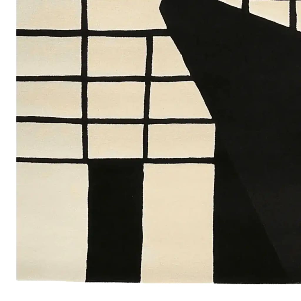 This image showcases a contemporary area rug featuring a striking monochrome grid pattern, hand-tufted for a luxurious feel. Crafted from high-quality wool, this 8x10 rug is perfect for enhancing any living room space with its modern design.