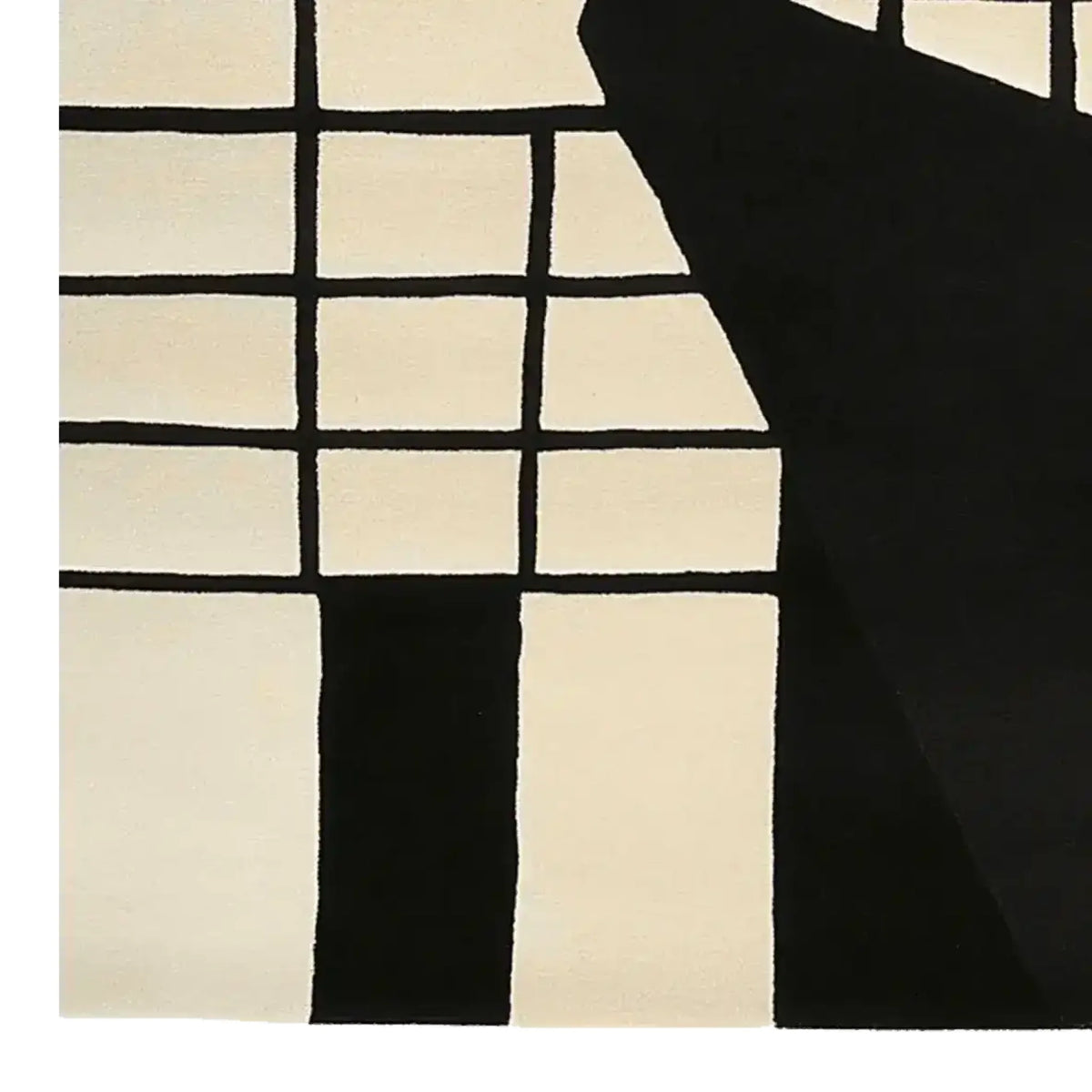 This image showcases a contemporary area rug featuring a striking monochrome grid pattern, hand-tufted for a luxurious feel. Crafted from high-quality wool, this 8x10 rug is perfect for enhancing any living room space with its modern design.