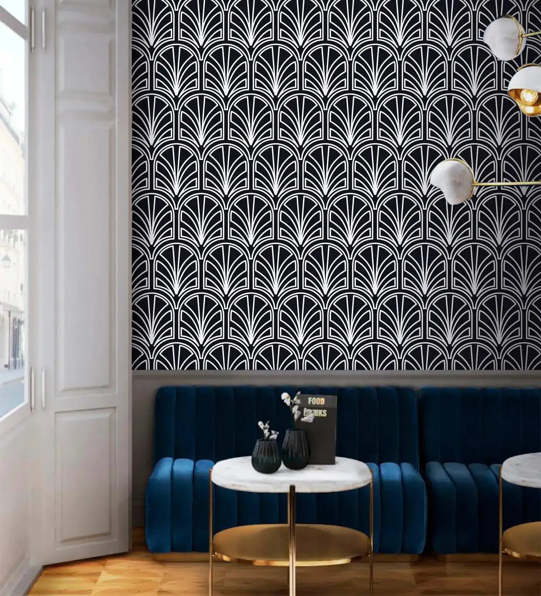 Monochrome vintage geometric wallpaper, white deco palmettes on navy above a blue velvet banquette