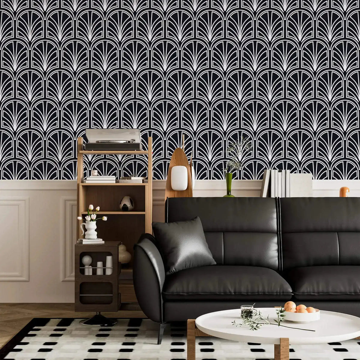 Monochrome vintage geometric wallpaper, white deco palmettes on navy above a black leather sofa