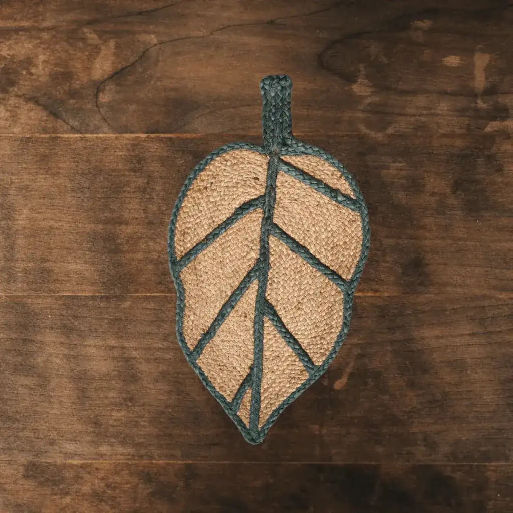 A unique Monstera leaf-shaped area rug crafted from natural jute, ideal for adding a touch of nature to living rooms or offices. This stylish jute rug features a detailed leaf design, perfect for those seeking eco-friendly living room area rugs or rugs for the office.