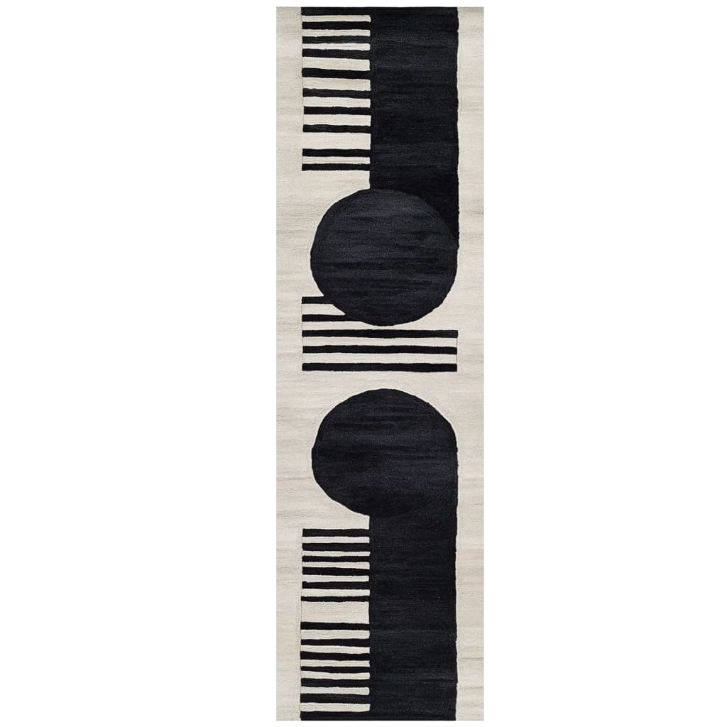 The Moon Edge Hand Tufted Wool Rug features a striking contemporary design with bold black circles and stripes on a cream background. Perfect as a runner rug, this versatile piece complements kitchen, hallway, or bathroom spaces, adding a touch of modern elegance.