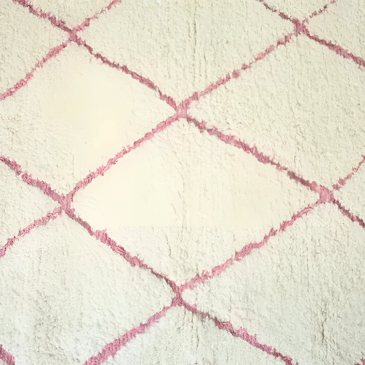 Close-up view of a Moroccan Pink Beni Ouarain Classic Area Rug, showcasing its plush wool texture and elegant pink diamond pattern. This large living room rug adds a touch of vintage charm to any space.
