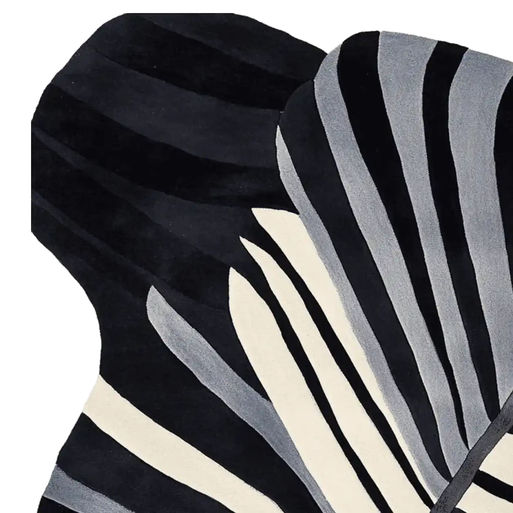 Close-up view of the Morph Flow Hand Tufted Area Rug, showcasing its striking black and white abstract design. This contemporary wool rug is ideal for adding a stylish touch to your living room decor. Perfect as a large living room rug, its unique pattern provides a modern aesthetic.