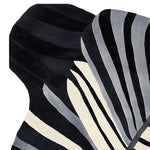 Close-up view of the Morph Flow Hand Tufted Area Rug, showcasing its striking black and white abstract design. This contemporary wool rug is ideal for adding a stylish touch to your living room decor. Perfect as a large living room rug, its unique pattern provides a modern aesthetic.