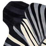 Close-up view of the Morph Flow Hand Tufted Area Rug, showcasing its striking black and white abstract design. This contemporary wool rug is ideal for adding a stylish touch to your living room decor. Perfect as a large living room rug, its unique pattern provides a modern aesthetic.