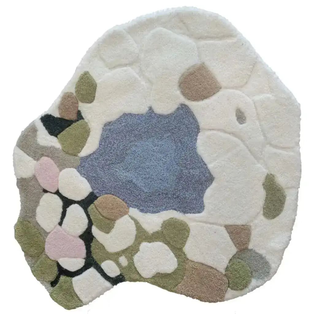 A uniquely shaped, hand-tufted wool area rug titled 'Moss and Meadow'. This large area rug features an abstract design with soft pastel colors including blues, greens, and pinks, making it perfect for adding a touch of creativity to an office space. Ideal for those seeking rugs for office settings.
