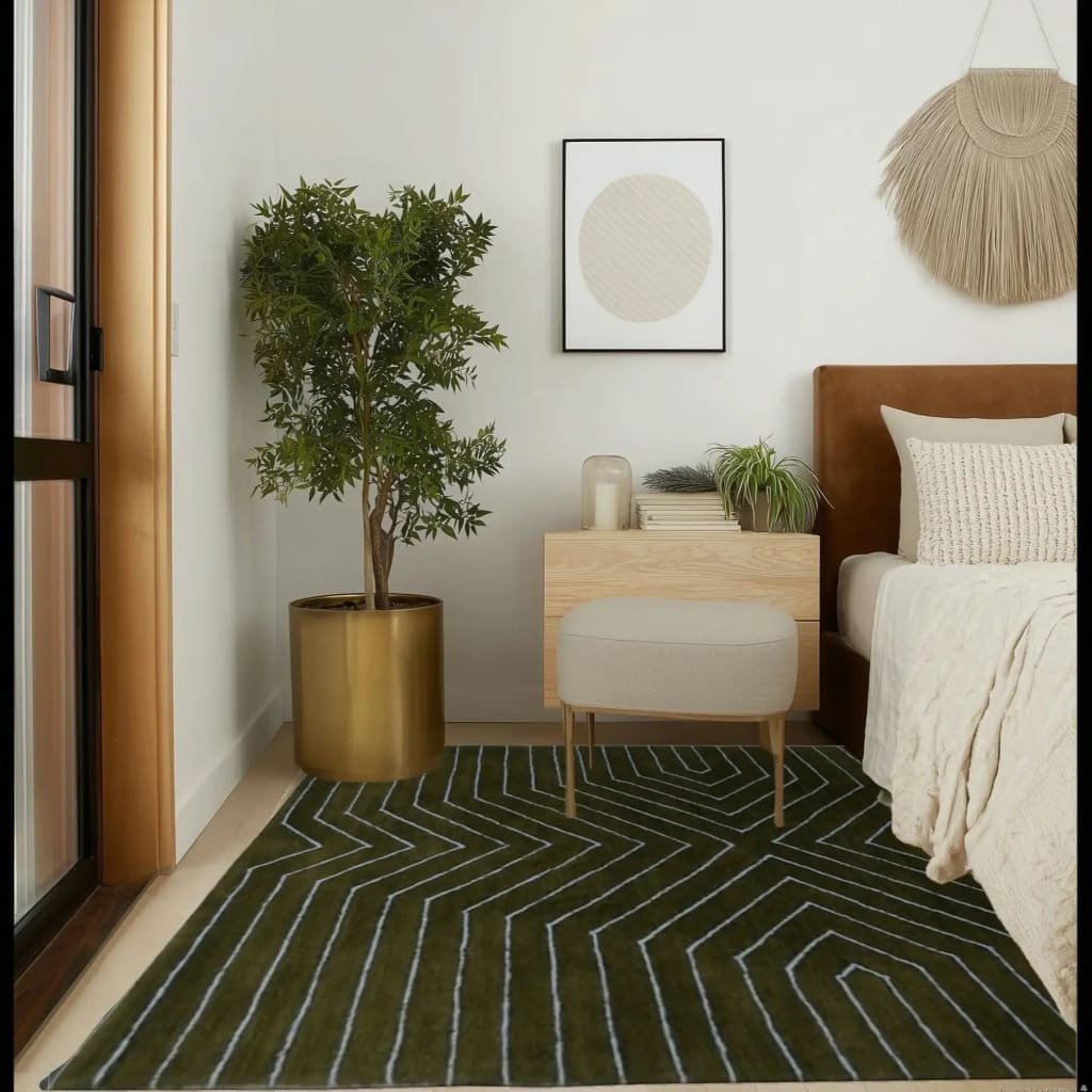 The Moss Green Geometric Hand Tufted Wool Rug is showcased in a modern bedroom setting. This contemporary rug, ideal for a dining room or living room, features a striking geometric pattern that adds a touch of elegance. Its deep moss green tones complement the neutral decor, while the wool material ensures comfort and durability, making it perfect for formal dining room settings and large living areas.
