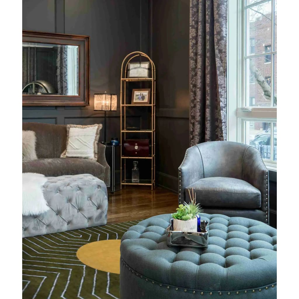 A stylish living room featuring a Moss Green Gold Circle Geometric Hand Tufted Wool Rug. This contemporary area rug enhances the elegant space with its unique pattern, perfectly complementing the plush seating and modern decor of the room. Ideal for dining rooms or as an 8x10 living room area rug, this wool rug adds a touch of sophistication and warmth.