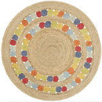 Beautifully designed Motley Braided Round Jute Rug serving as a stunning area rug, perfect for a dining table or living room. This large, boho-style rug features a natural jute texture with vibrant, multicolored braided patterns that add a touch of elegance to any dining room or living space.