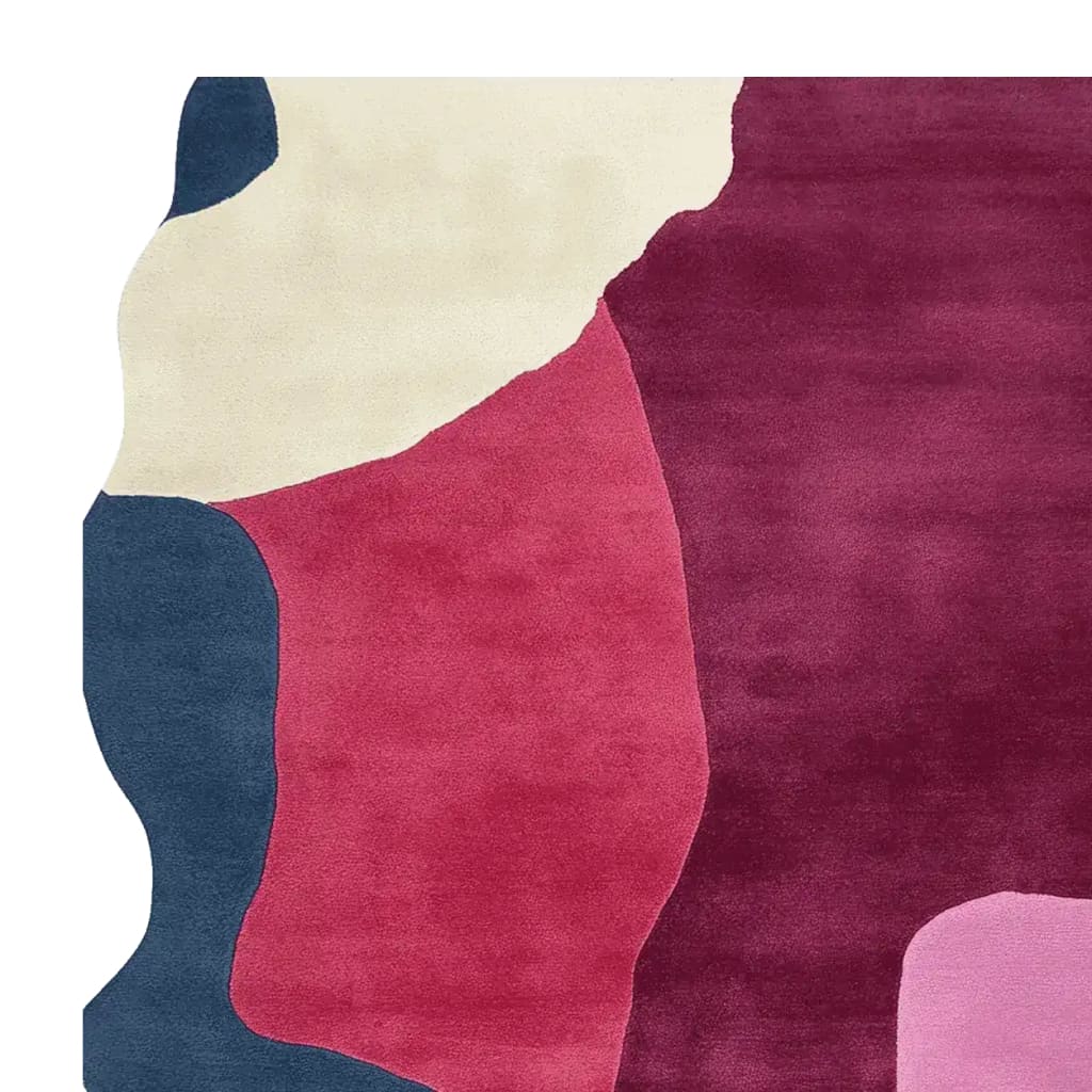 A vibrant area rug featuring a contemporary abstract design with bold colors including deep blue, rich red, cream, and pink. This wool rug is perfect for adding a touch of modern elegance to large living rooms.