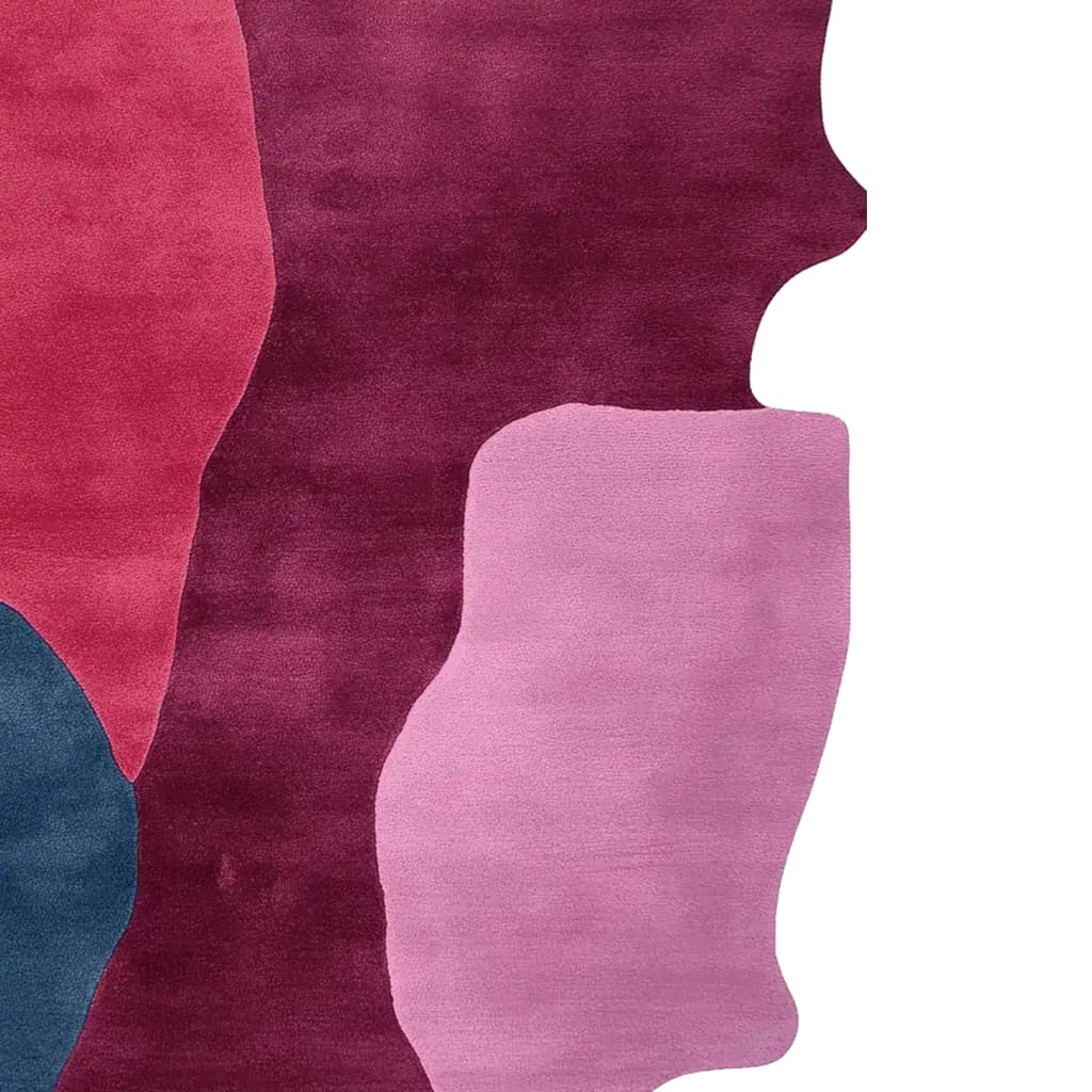 A colorful area rug featuring bold, abstract shapes in shades of burgundy, pink, and blue. This contemporary wool rug is ideal for large living rooms, adding a modern touch with its hand-tufted design.