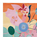 Vibrant contemporary area rug showcasing an abstract design with colorful shapes in pink, orange, blue, and green tones. This hand-tufted wool rug is perfect for adding a splash of color to living room area rugs, making it an ideal choice for those seeking unique area rugs for their living room.