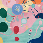 A vibrant and colorful area rug featuring an abstract design with bold shapes and colors, perfect for adding a contemporary touch to any living room. This wool rug showcases a playful mix of pink, blue, green, and yellow, making it an ideal choice for those seeking unique area rugs for living room decor.