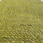 Close-up view of a mustard and gray braided jute area rug, ideal for adding a natural touch to dining rooms or as living room rugs 8x10. This durable jute rug is perfect for enhancing the aesthetic of any living room.
