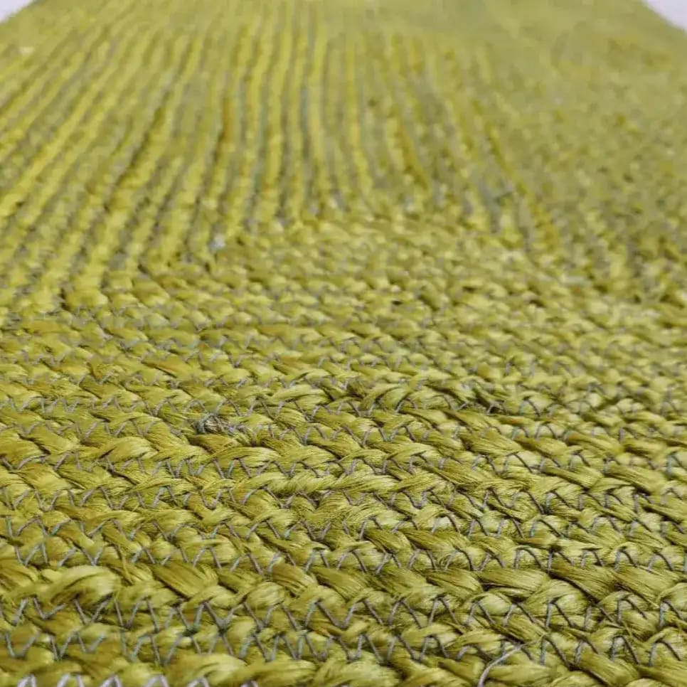 Close-up view of a mustard and gray braided jute area rug, ideal for adding a natural touch to dining rooms or as living room rugs 8x10. This durable jute rug is perfect for enhancing the aesthetic of any living room.