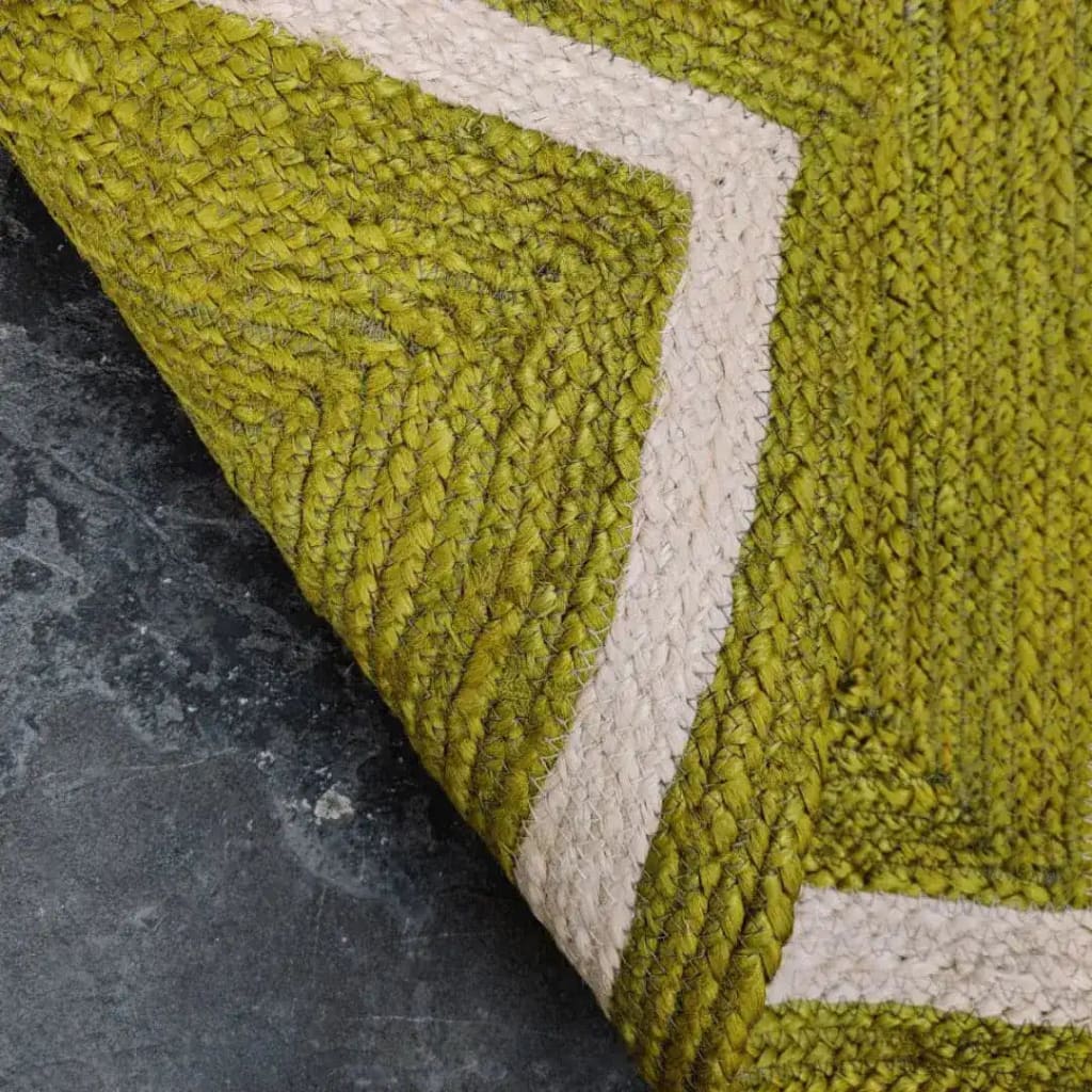Close-up of a mustard and gray braided jute area rug, showcasing its intricate texture and pattern. Ideal for dining rooms or as an 8x10 living room rug, this piece adds a natural touch to any space.