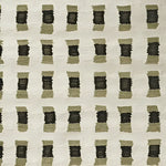 Close-up view of a contemporary hand-knotted wool area rug featuring a modern geometric pattern in muted tones, ideal for enhancing living room spaces.