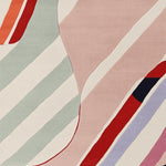 Close-up view of a contemporary hand-tufted wool area rug featuring muted shapes and dynamic stripes in pastel and bold colors. Ideal for enhancing large living room spaces, this rug blends modern design with comfort.